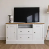 The 4ft Hinwick TV media base unit painted in Strong White with a solid oak worktop, a Shaker cupboard to each side and two central drawers below an open media shelf, holding a flatscreen television and stone candlesticks