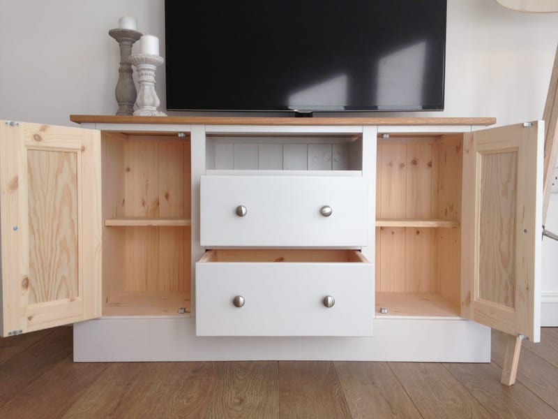 The TV media unit with both cupboard doors open and drawers pulled out, revealing natural pine interiors with adjustable shelves and a tongue-and-groove pine back panel