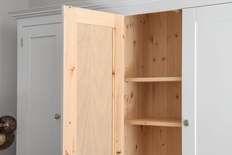 An upper door of the Welsh dresser opened to reveal the natural solid pine interior with adjustable shelves and a tongue-and-groove pine back panel