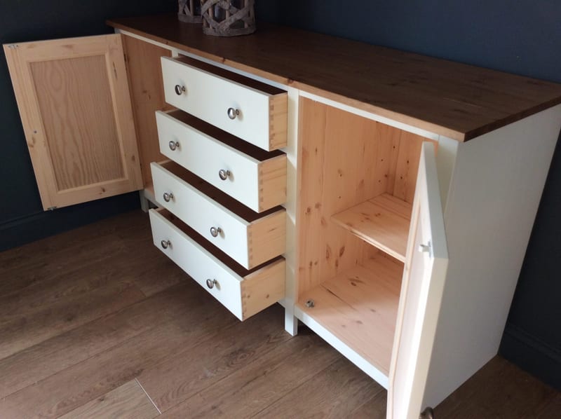 Both doors open and all four drawers pulled out, showing the natural pine drawer boxes, the pine lined carcass with an adjustable shelf and the panelled inner face of the left-hand door