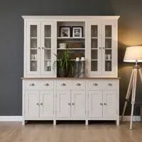 Cream painted 6ft Welsh dresser with glazed doors either side of an open shelf holding framed prints, above an oak worktop with three cup handled drawers and six cupboard doors