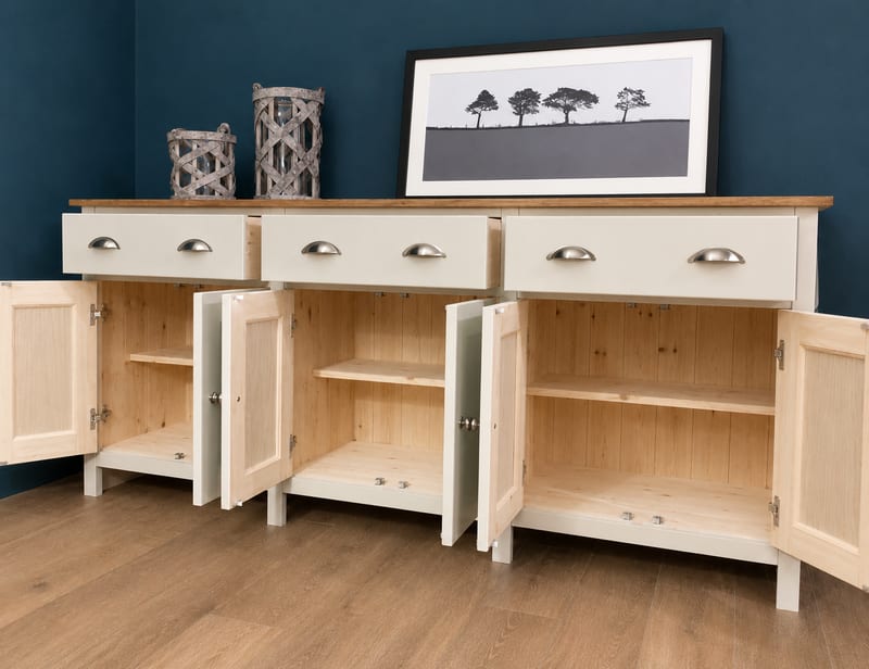 View of the sideboard with all six doors open, revealing natural pine interiors with tongue-and-groove backs and a shelf in each bay, the three drawers closed with nickel cup handles above