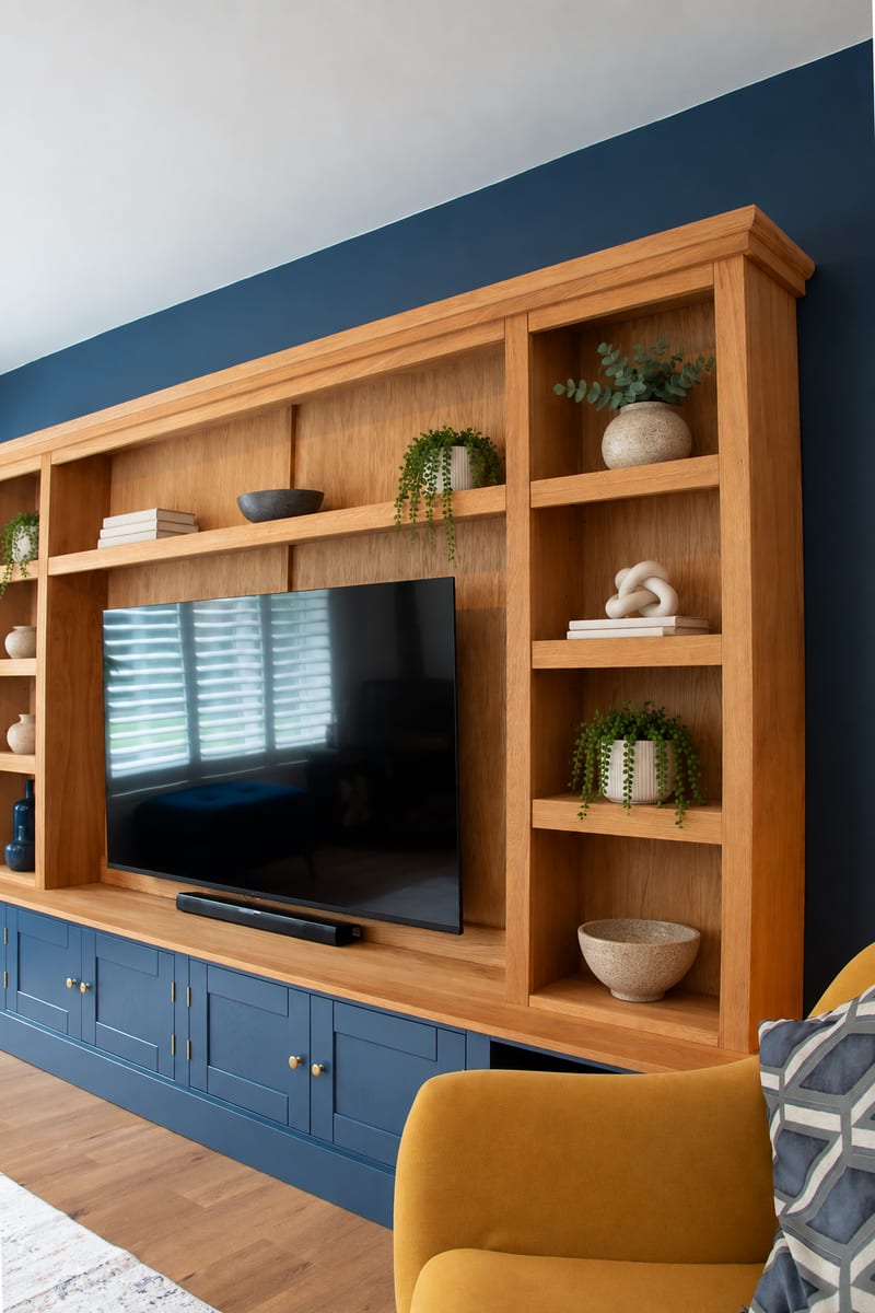 Side view along the length of the oak top section and navy base cupboards, with a mustard armchair in the foreground