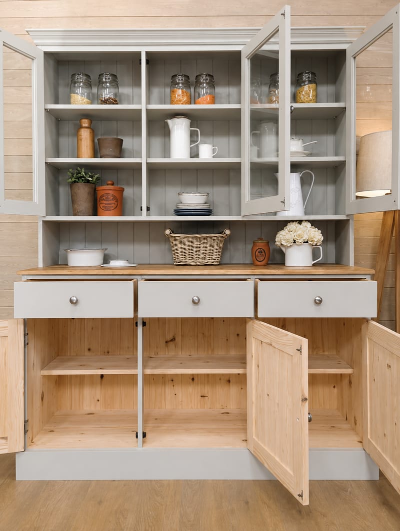 Front view with every door open, showing the grey painted upper shelves and the natural unpainted pine interior of the base cupboards below three painted drawers with brushed nickel knobs