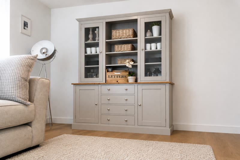 Grey painted 5ft Hinwick Welsh dresser with glazed doors either side of open shelves holding wicker baskets, above four drawers set between two cupboards