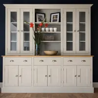 Grey painted 6ft Radwell Welsh dresser with glazed doors either side of an open plate shelf, above three cup handled drawers and six cupboard doors, against a deep navy wall