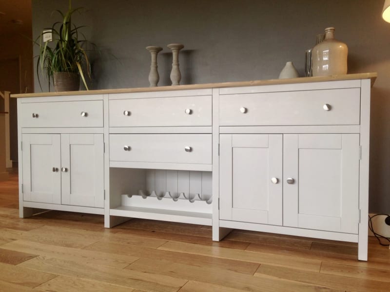 White painted 7ft Aspley sideboard on square legs with a solid oak top, three drawers, a cupboard at each end and an open wine rack in the centre bay