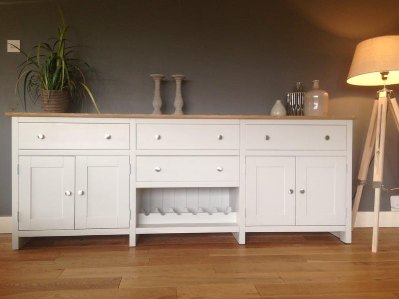 White painted 7ft Aspley sideboard on square legs with a solid oak top, three drawers, a cupboard at each end and an open wine rack in the centre bay