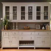Cream painted 7ft Aspley Welsh dresser with six glazed upper doors above an oak worktop, drawers, cupboards and a central wine rack, styled with candlesticks and a bowl of fruit