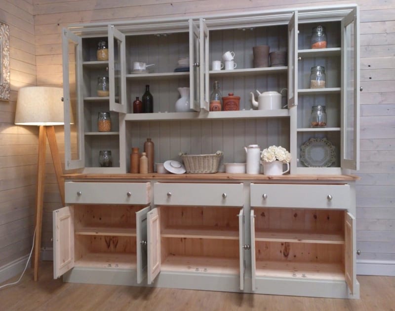 Full view with every door open, the glazed top doors revealing painted shelves and the base cupboards showing their natural pine interiors below three drawers and a waxed pine top