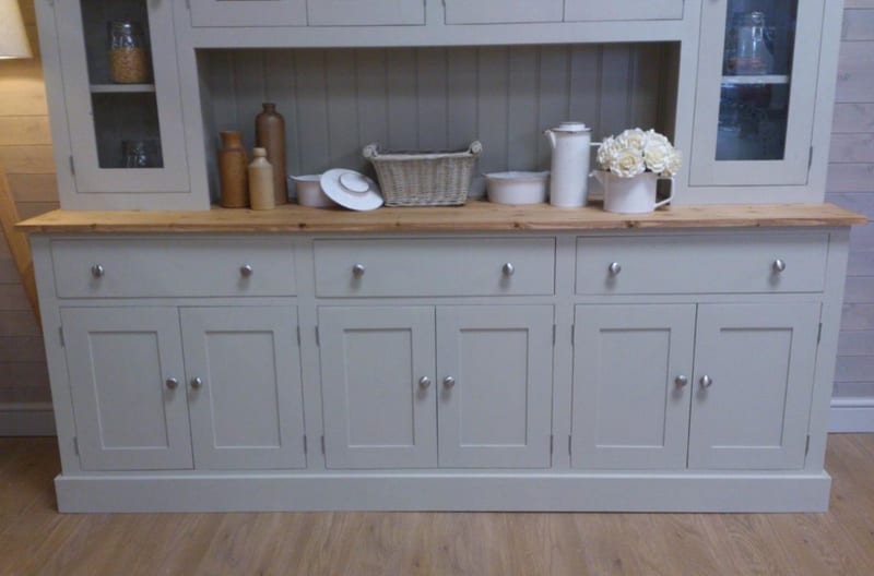 View of the painted base from the front, showing three drawers over six panelled cupboard doors with brushed nickel knobs, the pine top and the tongue-and-groove shelf above